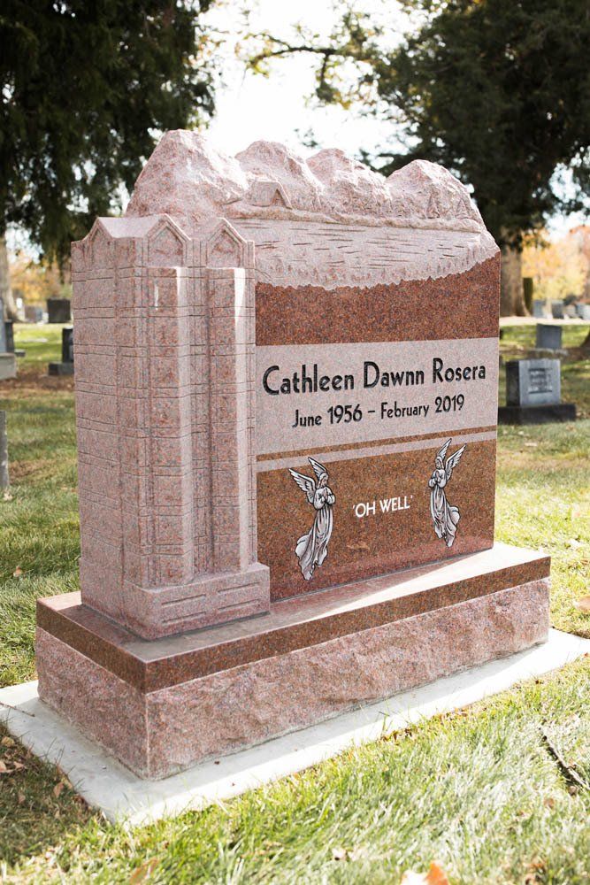 Side view of Cathleen Dawn Rosera memorial with detailed carvings and red granite finish