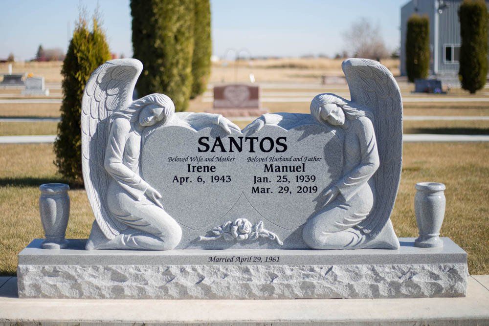 Front view of angel-themed Santos family headstone with heart centerpiece and engraved names
