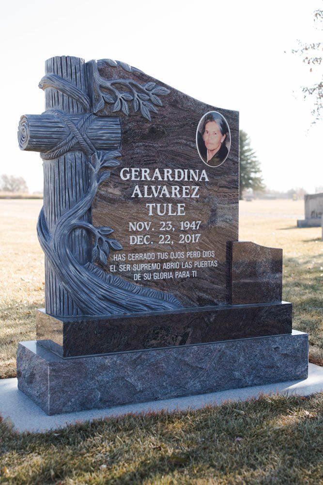 Polished headstone for Gerardina Alvarez Tule with floral accents and Spanish inscription