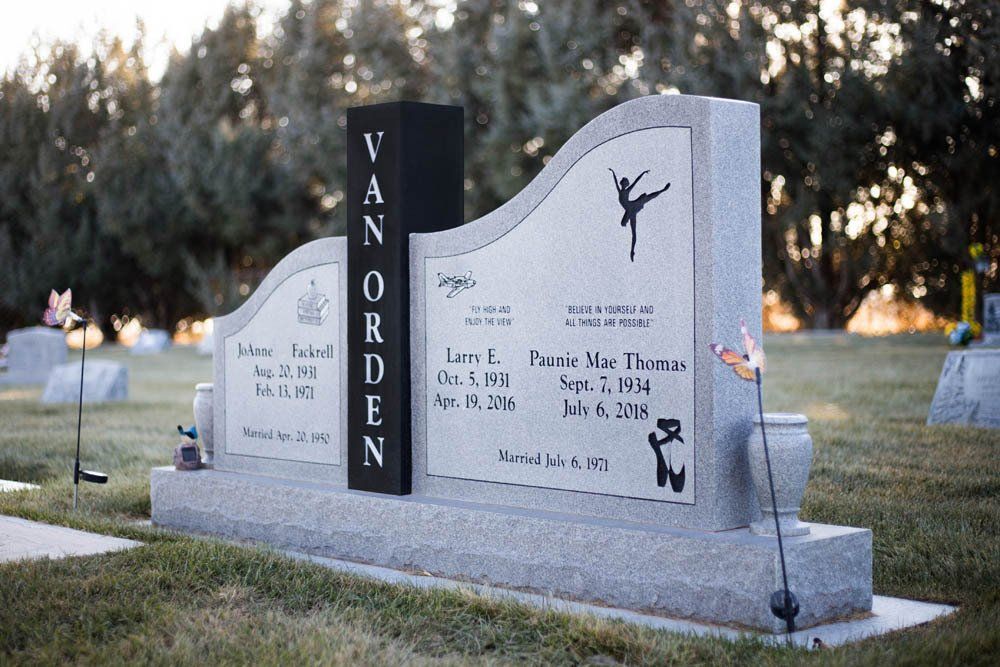 Modern dual monument headstone with the surname Van Orden featuring engraved dancers and books