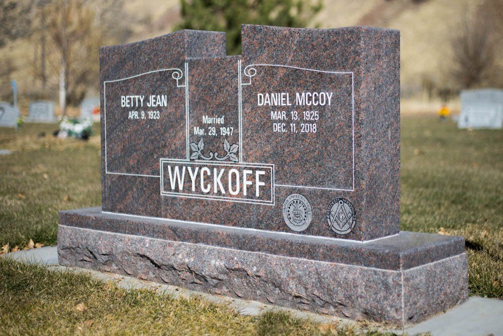 Custom granite headstone for Betty Jean and Daniel McCoy with surname ‘Wyckoff’ in cemetery setting