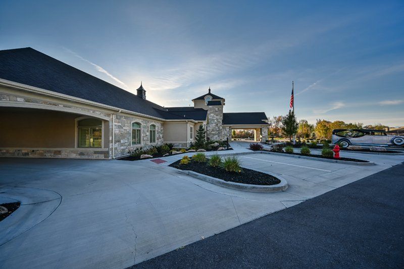 The outside of the White Pine Funeral Services funeral home including the road sign with logo.