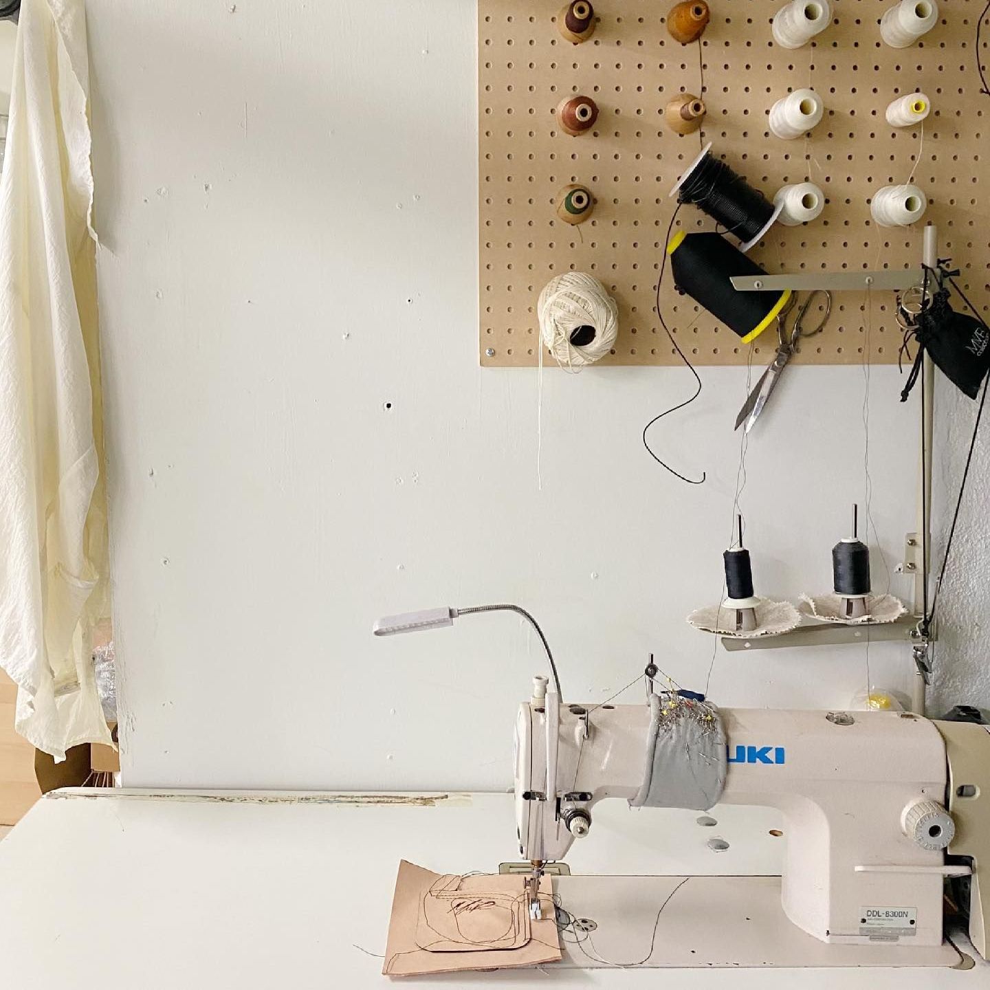 A white juki sewing machine is sitting on a table