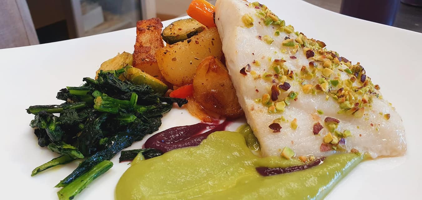 pesce bianco con granella di pistacchio e verdure