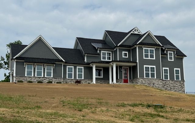 A Large House Sits on Top of A Grassy Hill — Pewee Valley, KY — Tracee Dore Builders