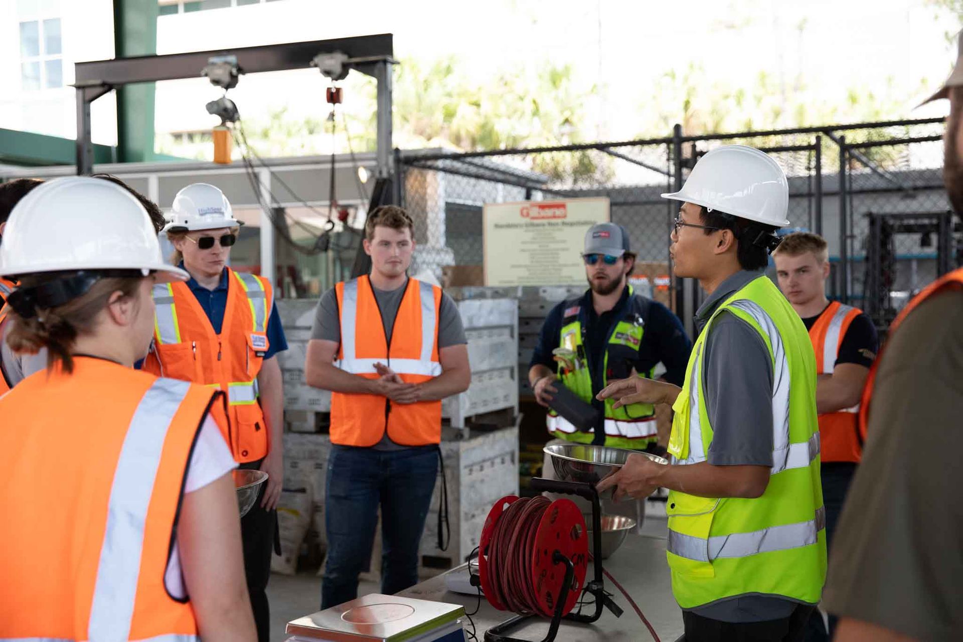 Group of construction workers in safety gear during a site safety briefing.