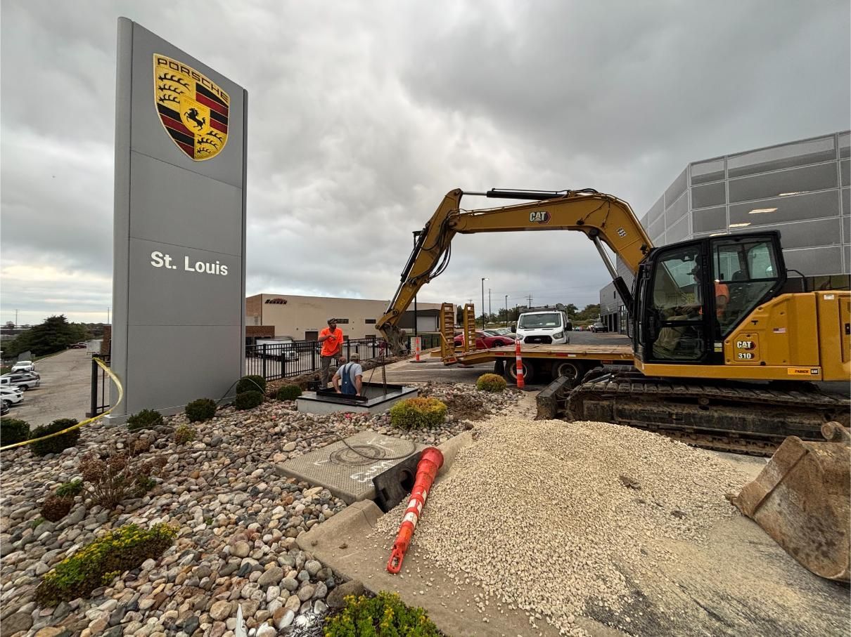 Construction workers discussing plans at a building site, surrounded by lumber and scaffolding.