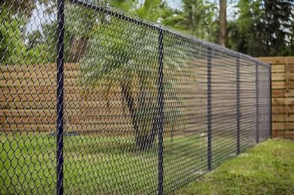 A black chain mesh fence installed for a big residential backyard Shellharbour NSW.
