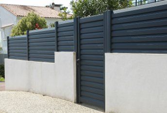 Great looking dark gray colorbond fencing and matching colorbond gates of a residential property in Wollongong NSW.