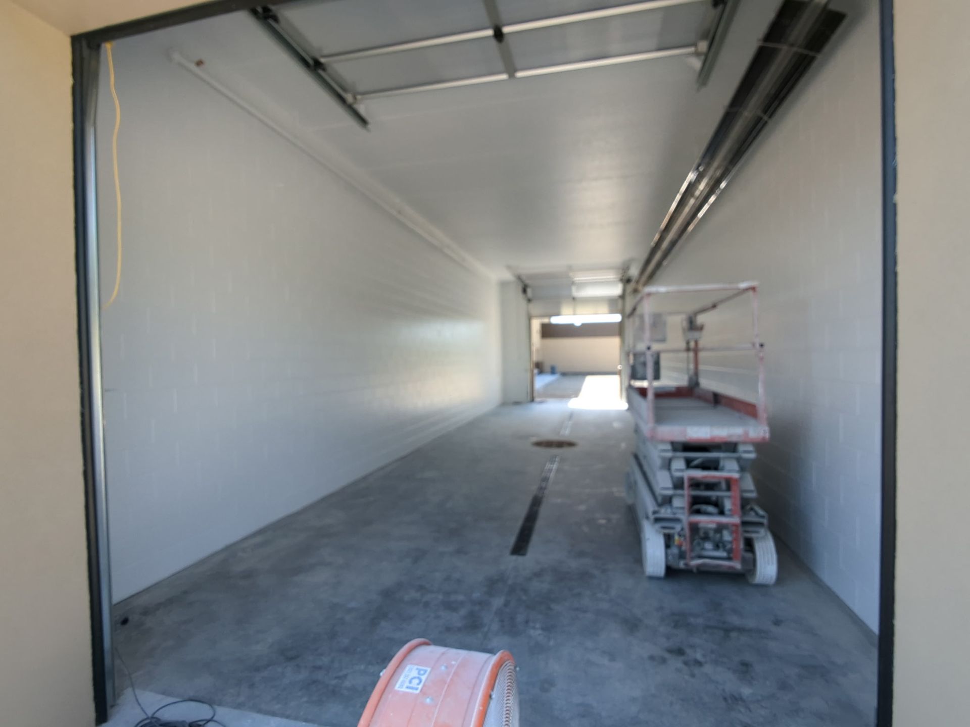 Open, empty industrial space with a lift.