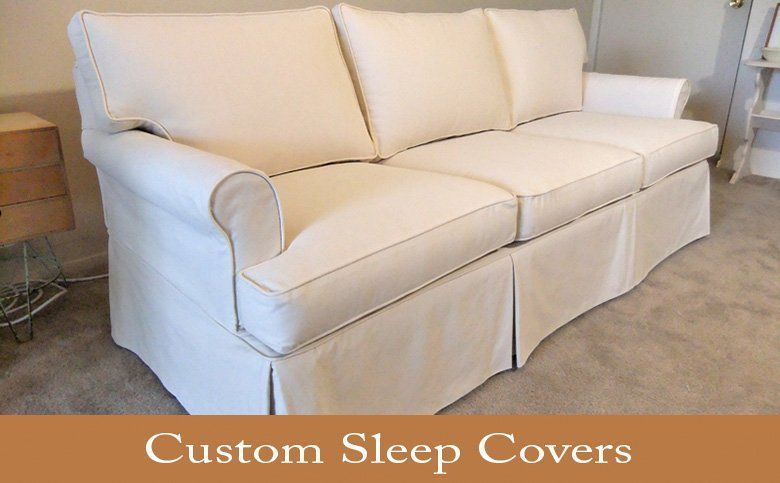 Cream-colored custom sleep cover on a sofa with skirt and rolled arms; text overlay 