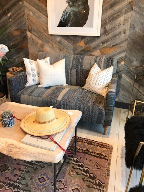 A cozy living room setting with a patterned sofa, wooden coffee table, and area rug.