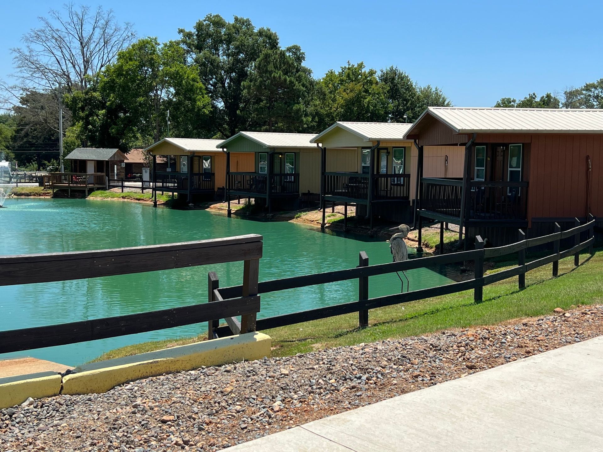 A row of small houses next to a lake.