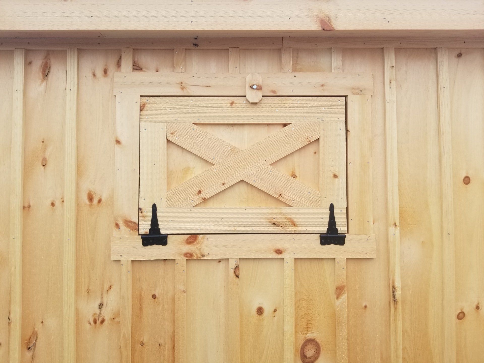 A wooden shed with a small window on the side