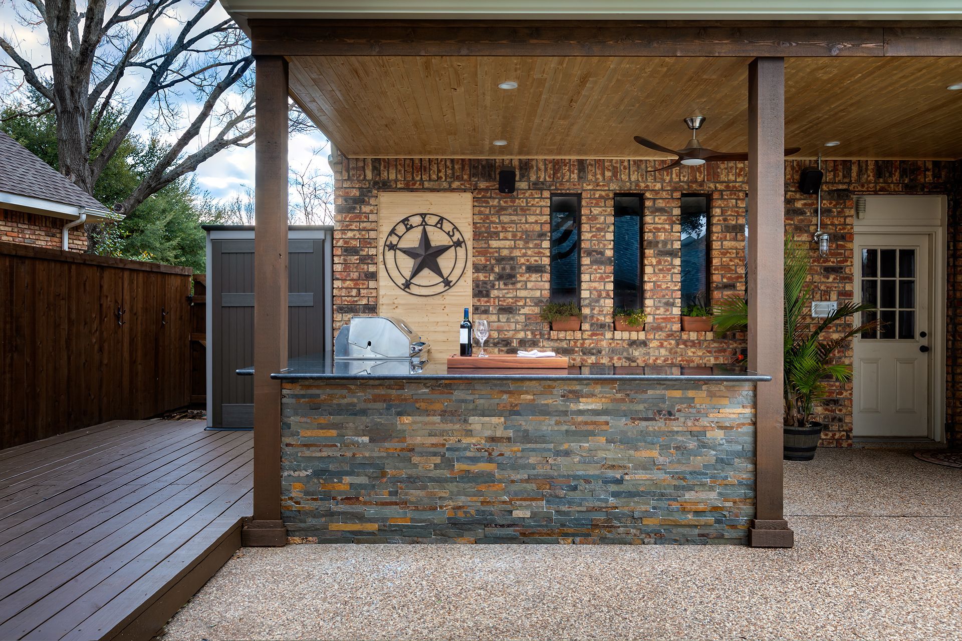 An outdoor kitchen with a texas star on the wall