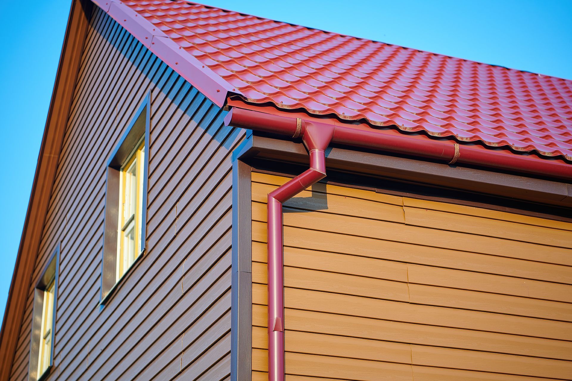 A house with a red roof and a red gutter.