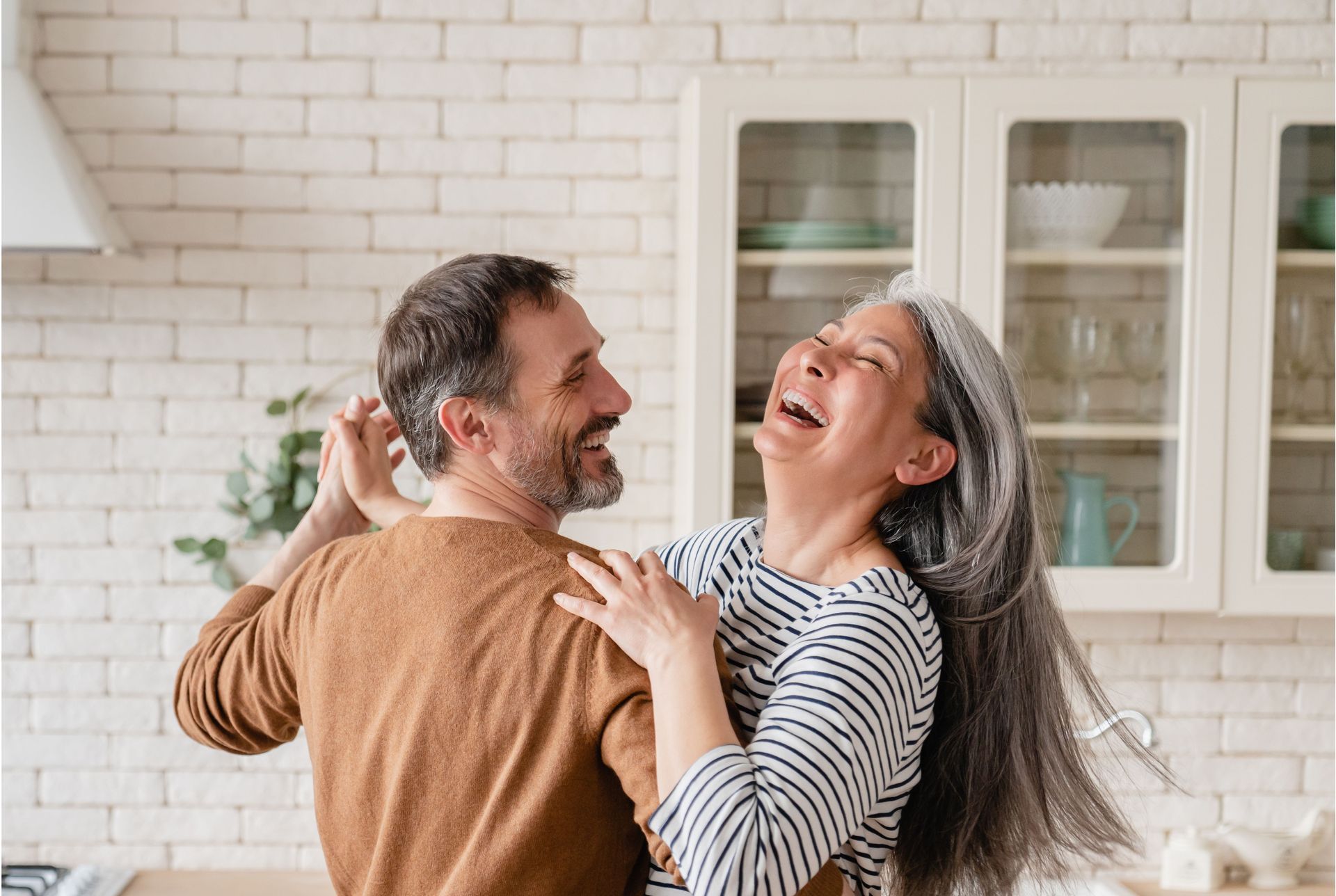 happy couple dancing in kitchen