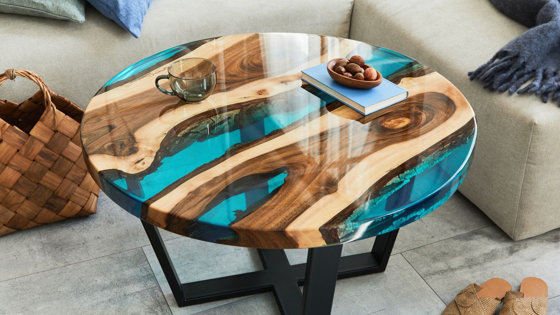 a round coffee table made of wood and resin in a living room .