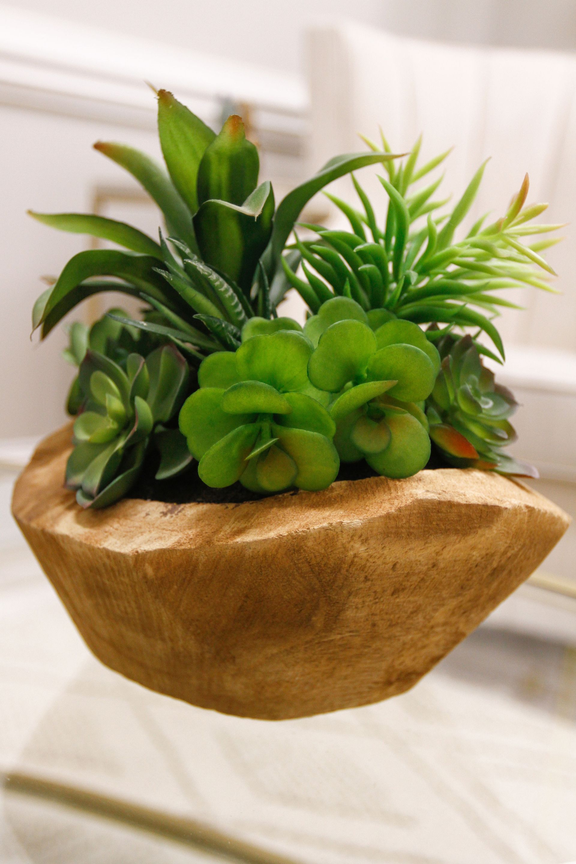 A woman is standing on top of a mountain with her arms crossed.
