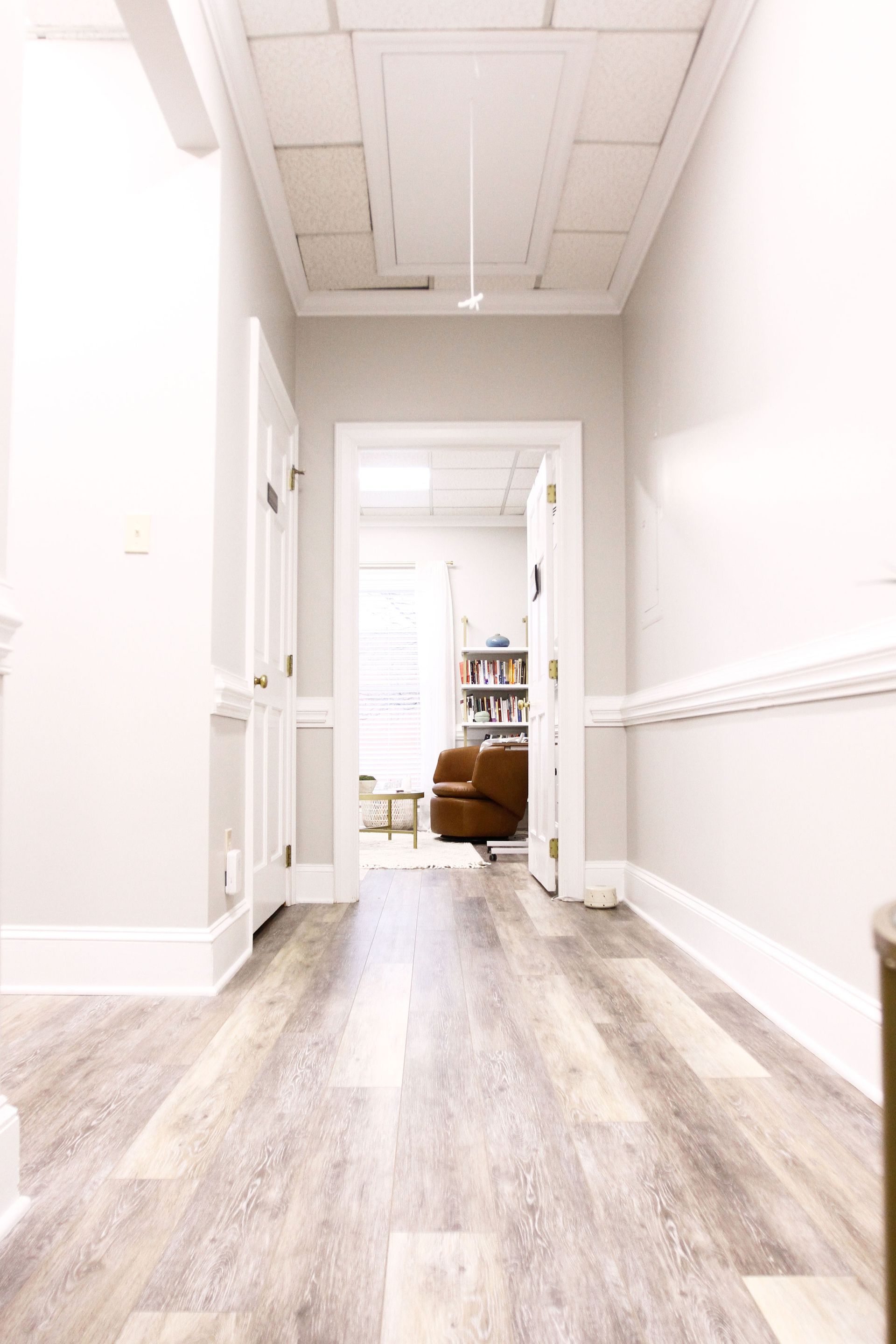 A woman is sitting in a chair talking to another woman.