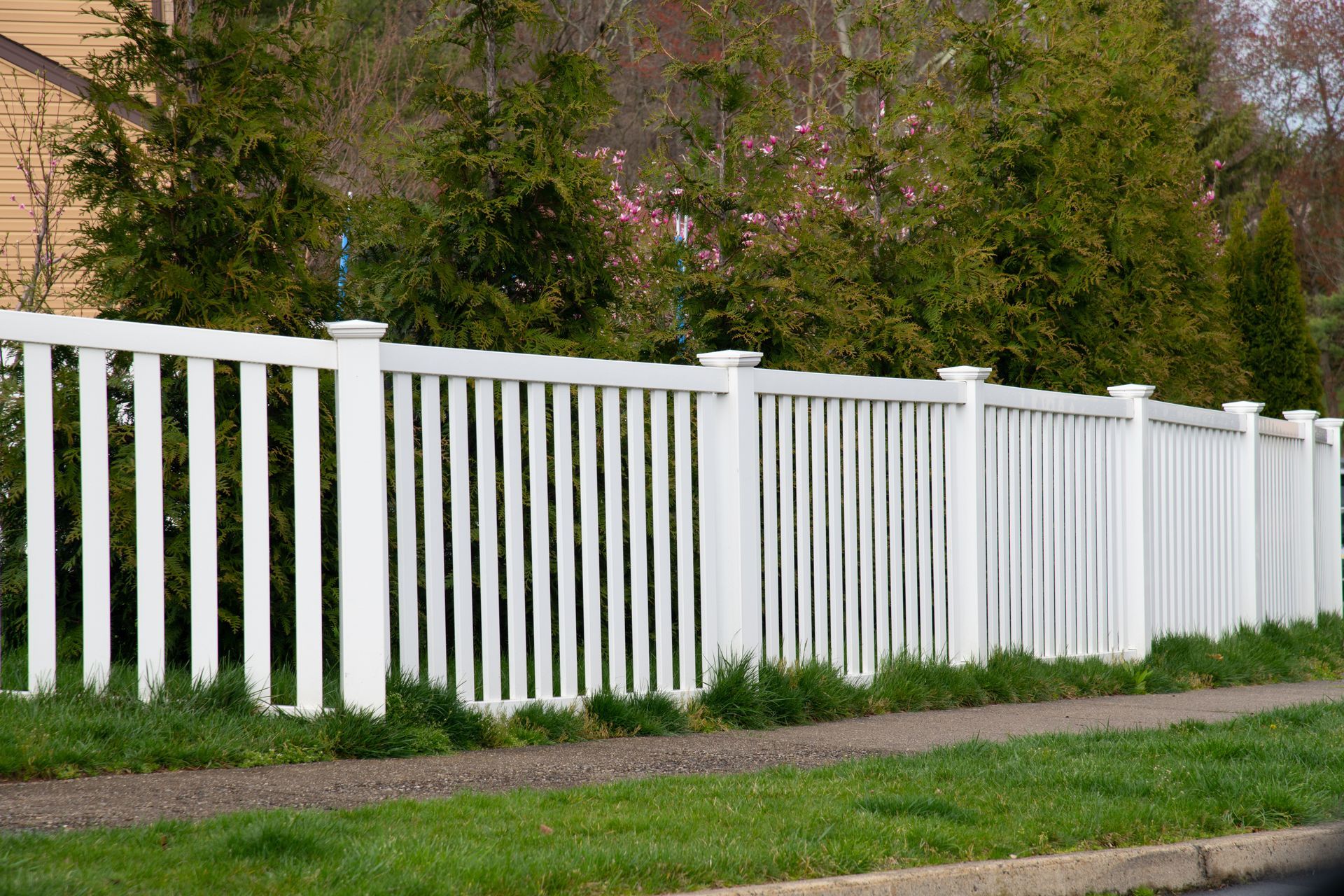 Close-up of light gray, textured retaining wall blocks stacked horizontally.