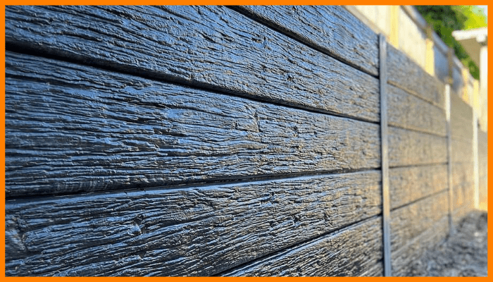 Close-up of smooth concrete sleeper retaining wall after rain in Canberra