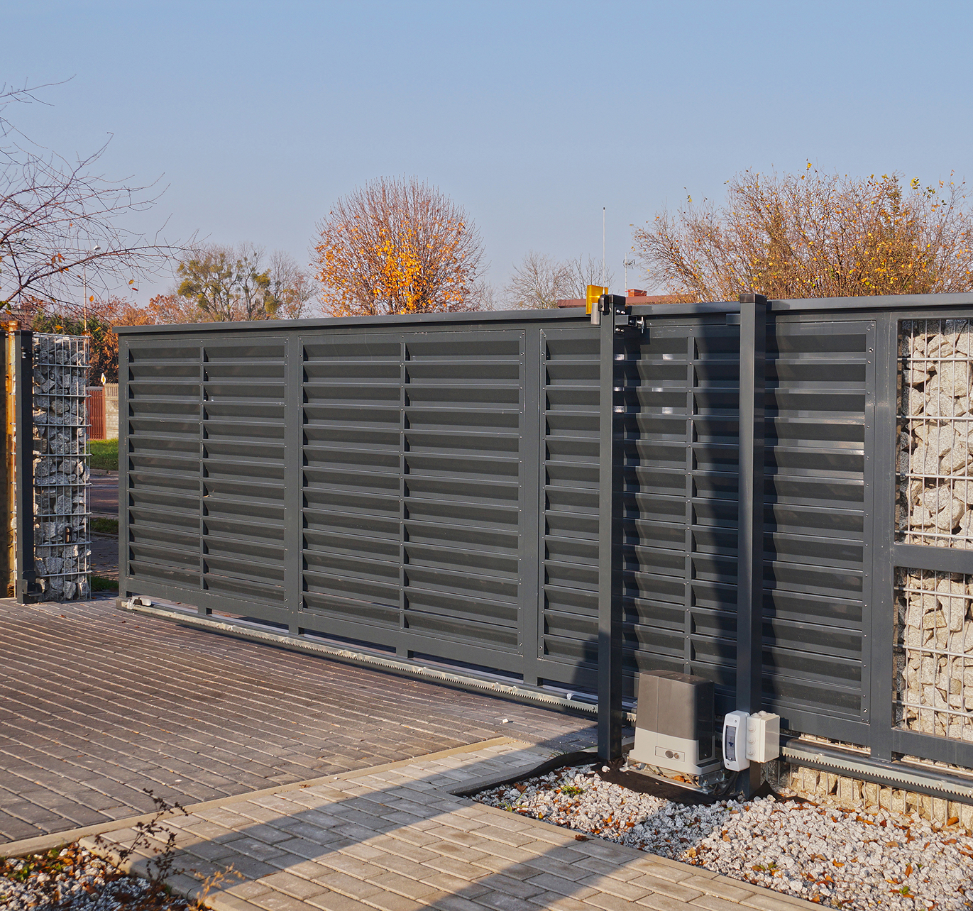 There is a sliding gate with a motor attached to it.