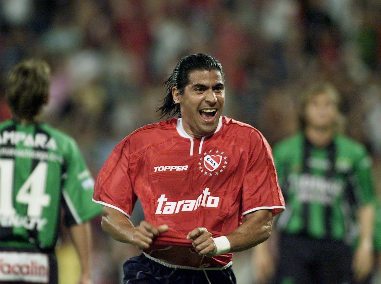 Eduardo Domínguez, entrenador de fútbol, mirando hacia un lado, vistiendo una camiseta oscura, sosteniendo una toalla.