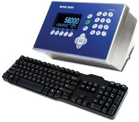 A computer monitor with the number 56000 on it next to a keyboard