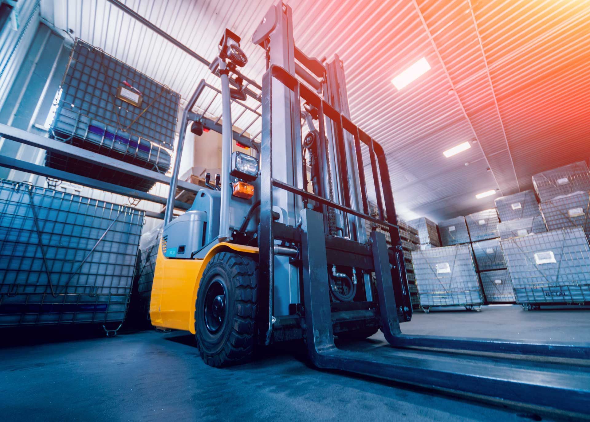 A forklift is moving boxes in a warehouse.