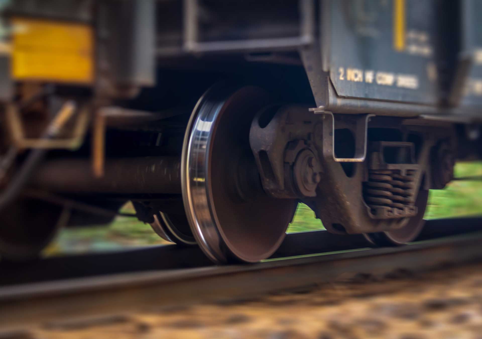 A close up of a train 's wheels on the tracks.