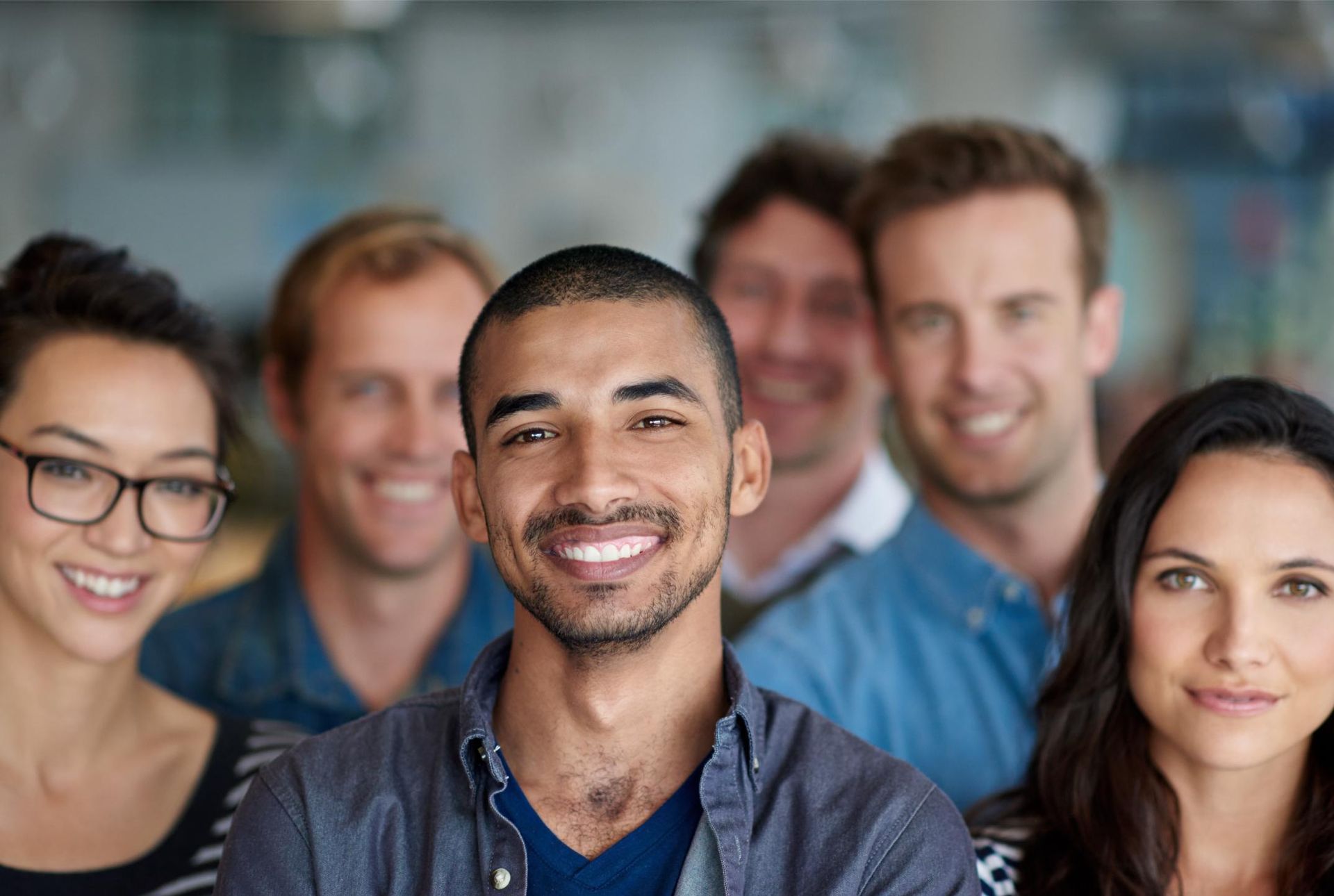 A group of people are posing for a picture together and smiling.