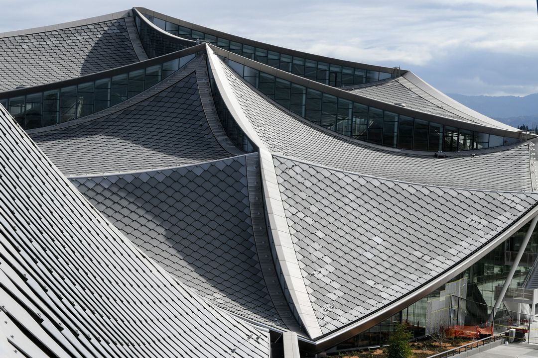 Modern building with patterned, angular roof panels.