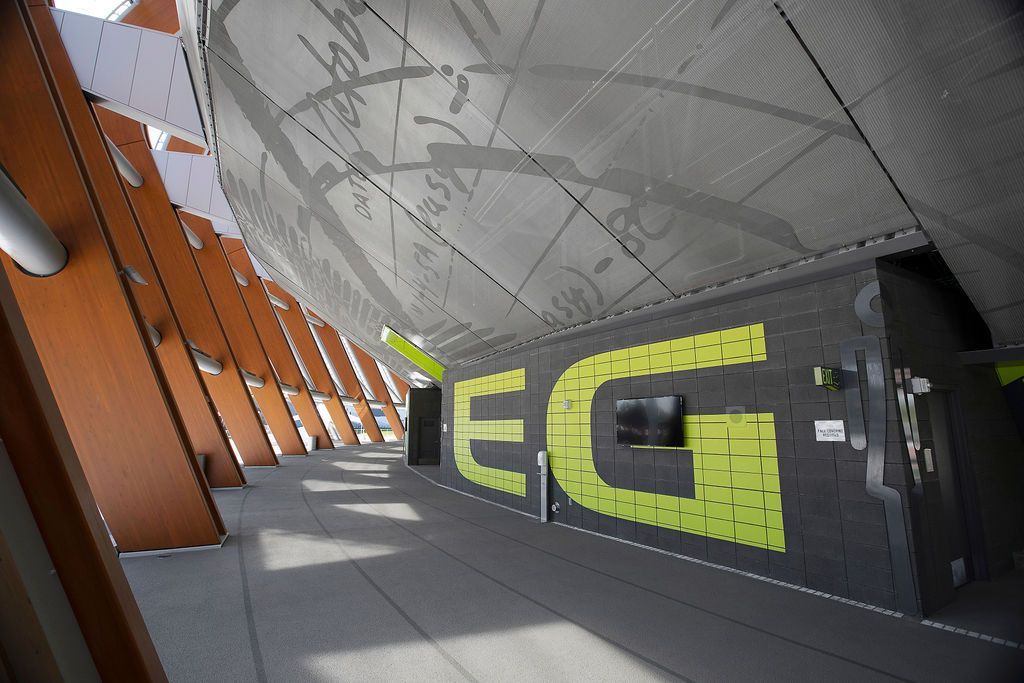 Exterior walkway with modern architecture: gray ceiling with patterns, lime green 