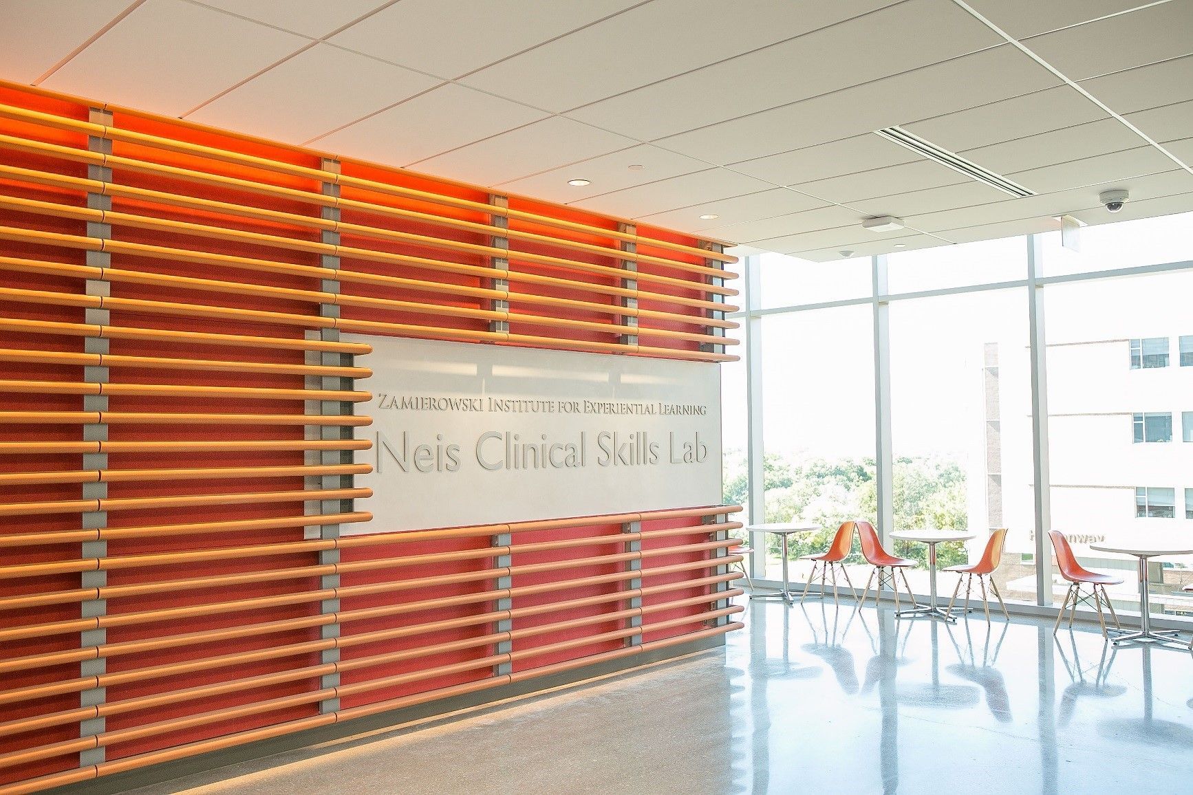 Orange and beige slatted wall with a sign reading 