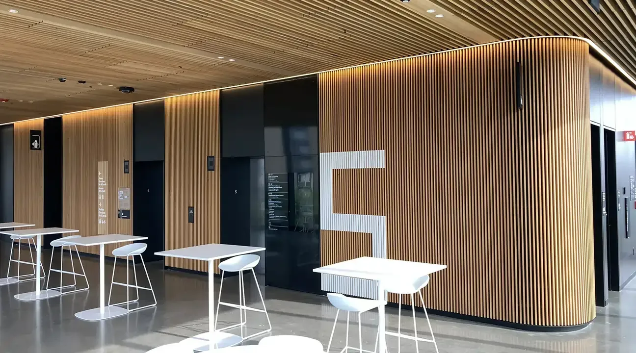 Modern interior with wood paneling, tables, and the letter 
