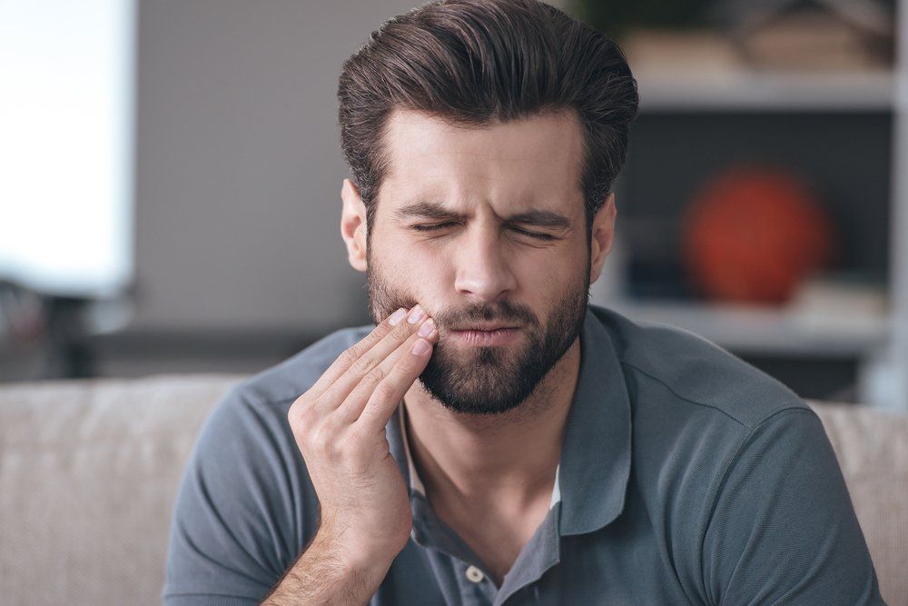 young man tooth ache expression