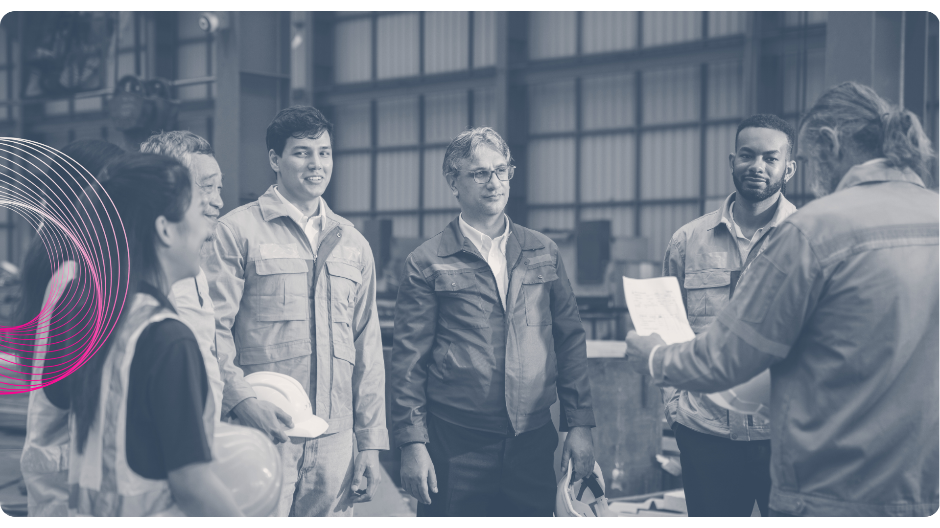 Three people in a meeting, one speaking at a whiteboard, the others listening, in an office.