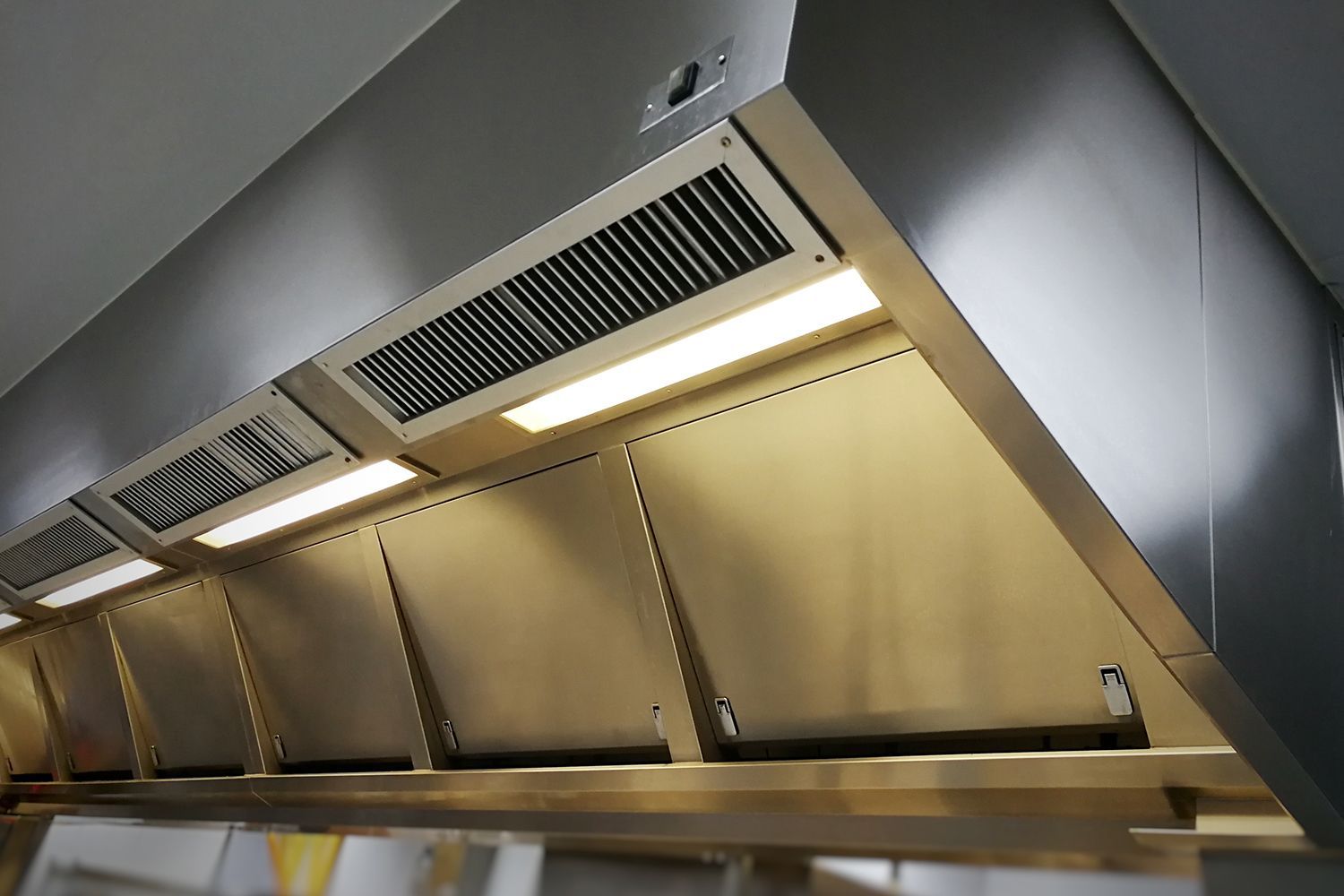 Commercial kitchen extraction hood with supply and return vents.