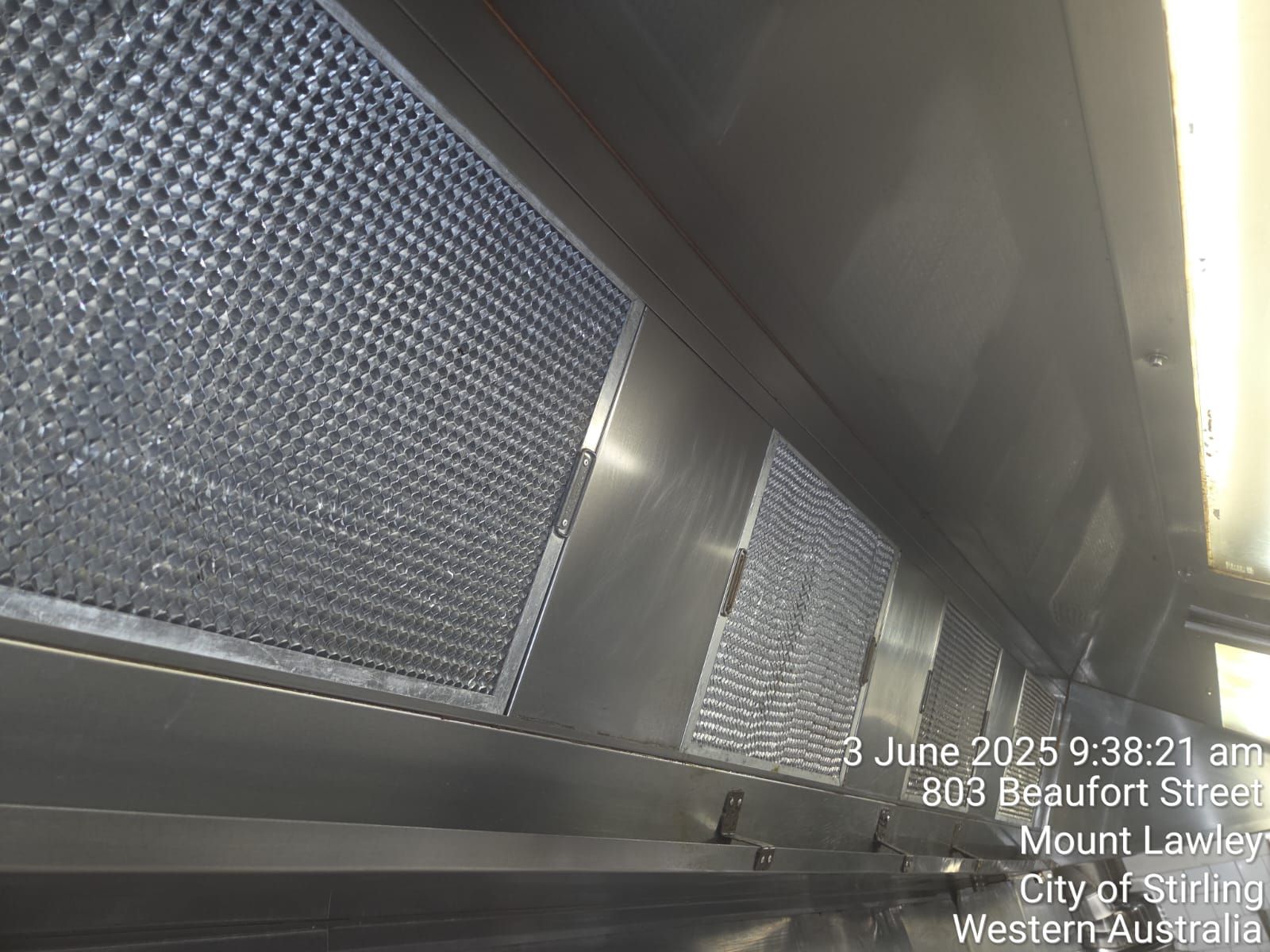 A stainless steel wall with a lot of white spots on it.