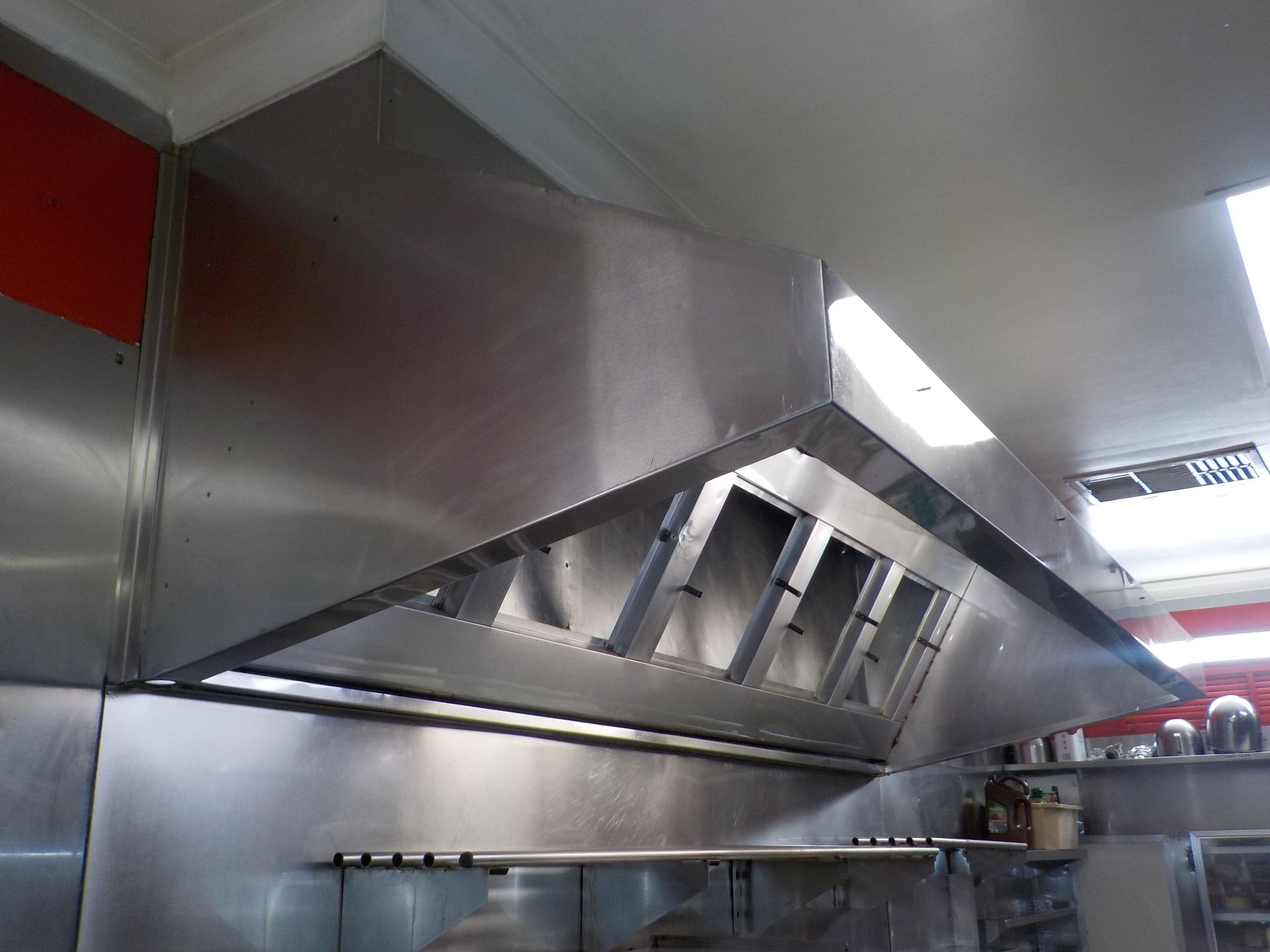 A stainless steel wall with a lot of white spots on it.