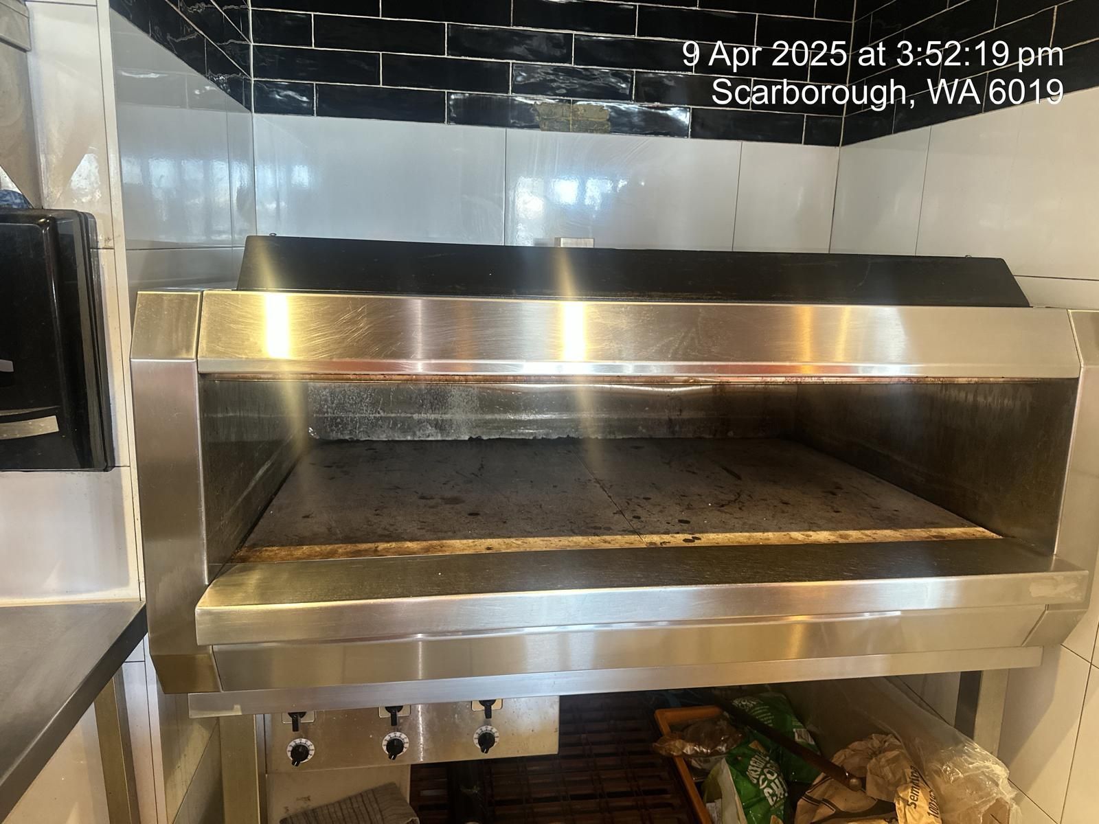 A stainless steel oven is sitting in a kitchen