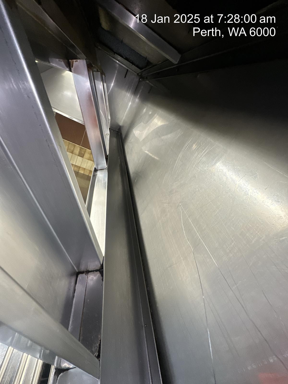 A close up of a stainless steel wall with a time stamp of 7:26 am