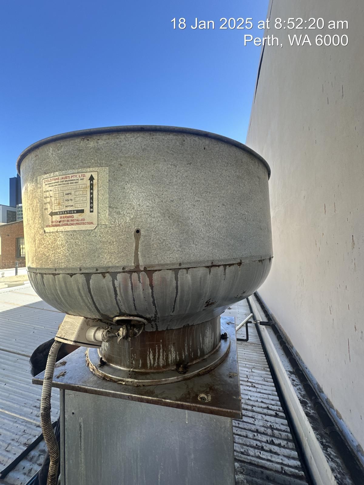 A large metal bowl is sitting on top of a metal box.