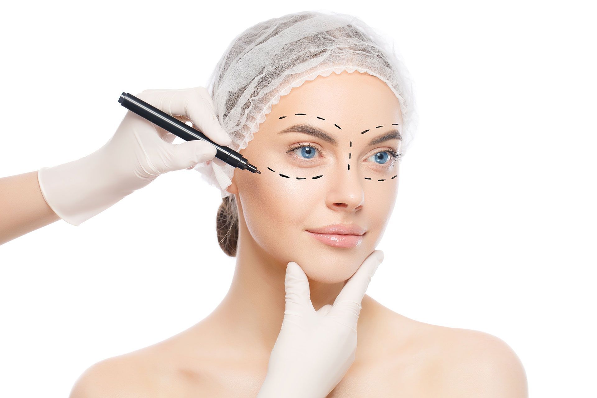 Plastic surgery or face lifting for young woman. Doctor's hands holding head, wearing gloves drawing lines with marker, isolated on white background
