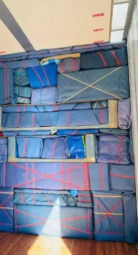A bunch of blankets are stacked on top of each other in a room.