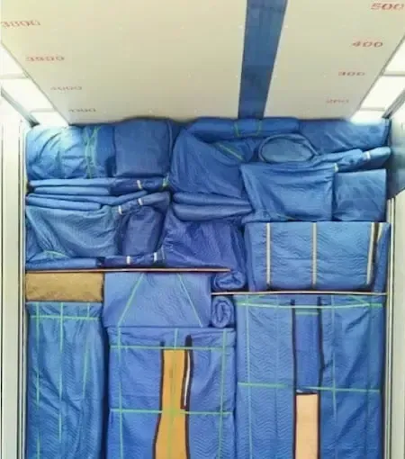 A bunch of blue blankets are stacked on top of each other