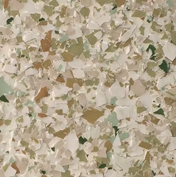 Speckled floor covering with white, green, and tan chips.