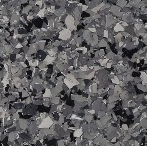 Close-up of a speckled flooring surface with gray, black, and white chips.