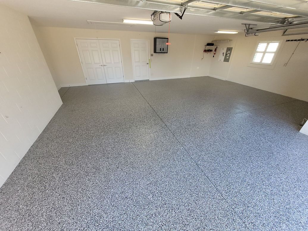 A room with a speckled, light-brown floor and a beam of sunlight.